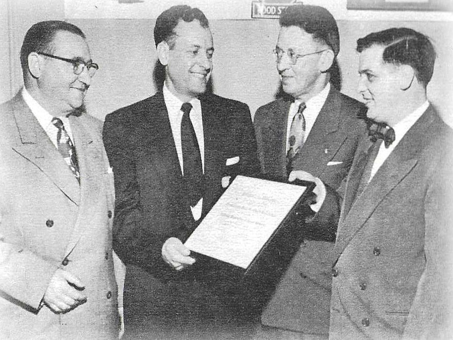 The Pennsylvania Food Merchants Association began during a charter presentation on October 29, 1952, in Erie. (From left) E.W. Haibach; Al Vicks; Vince L. Browner, president of the National Association of Retail Grocers; and Paul Reitz, first PFMA chair (then known as president).